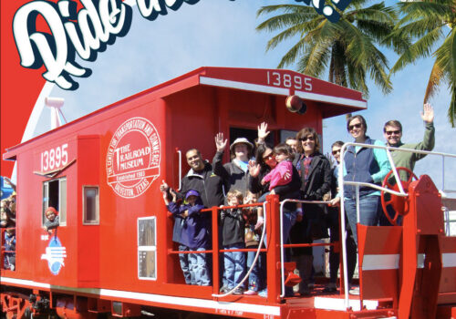 Group waving on red train car Group waving on red train car