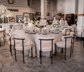 Elegant white wedding reception with round tables